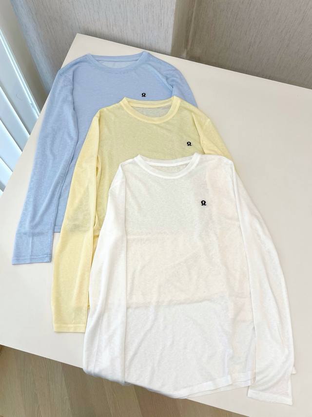 Round Neck Long Sleeve Tops In Light Blue, Light Yellow And White. There Is A Sm