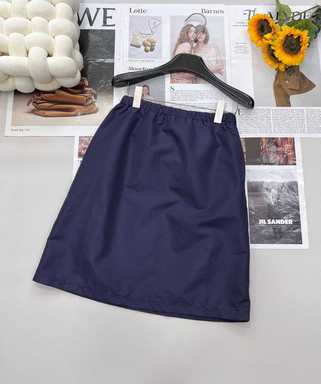 Prada's New Triangle Logo A-Line Skirt Has A Pocket Design On The Back That Brea