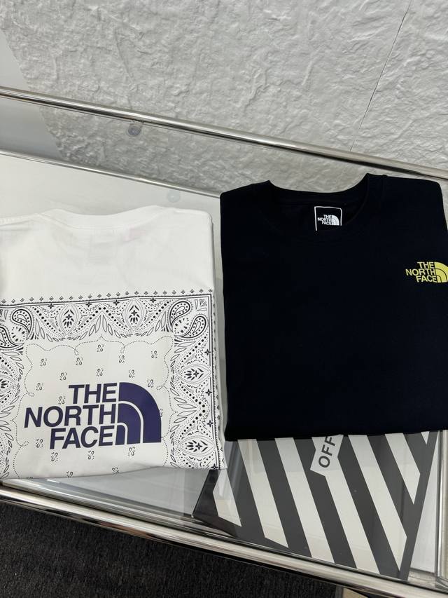 The North Face 25Ss Tnf cashew flower print on the back, round neck short-sleeve