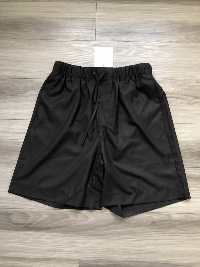 The Row solid color simple old money style casual suit shorts for men and women.