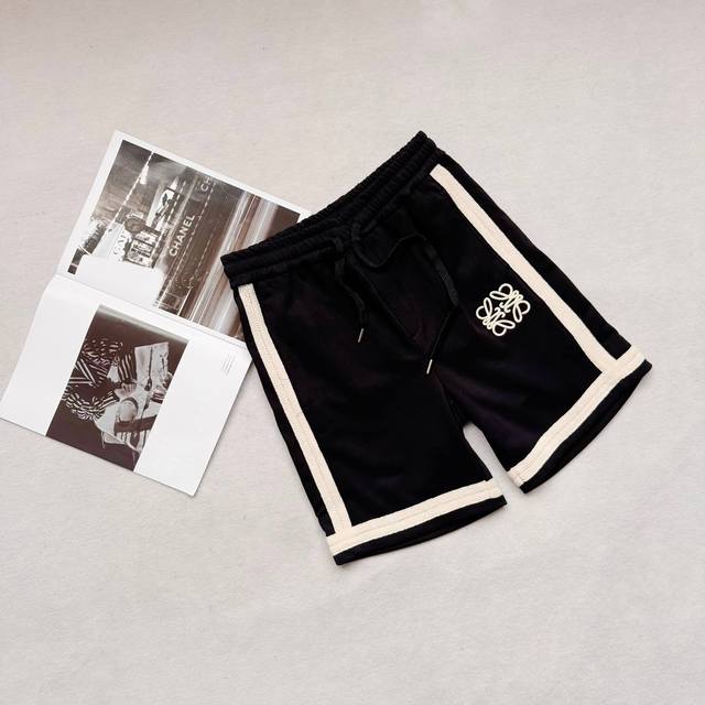 Loewe's official website is selling embroidered patchwork webbing shorts . Quali