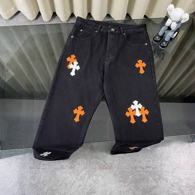 Chrome Heart classic black with orange laser cross leather jeans. The pants are