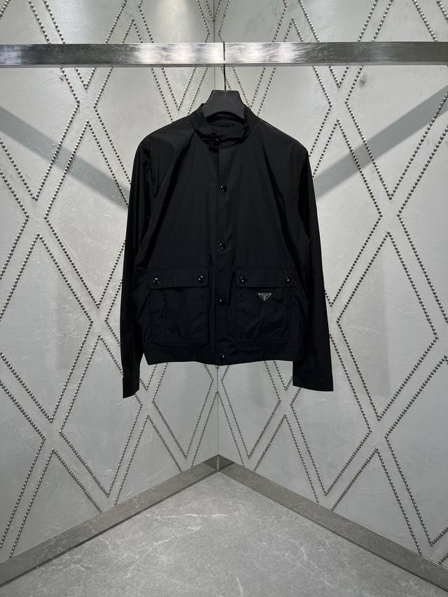 Prada's new 25Ss recycled nylon jacket combines practical details with clean lin