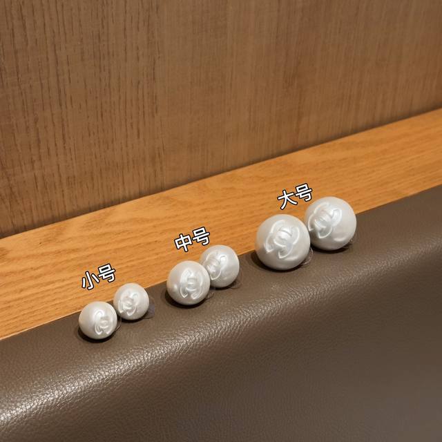 Small, medium and large Chanel's new classic pearl earrings that can be worn all