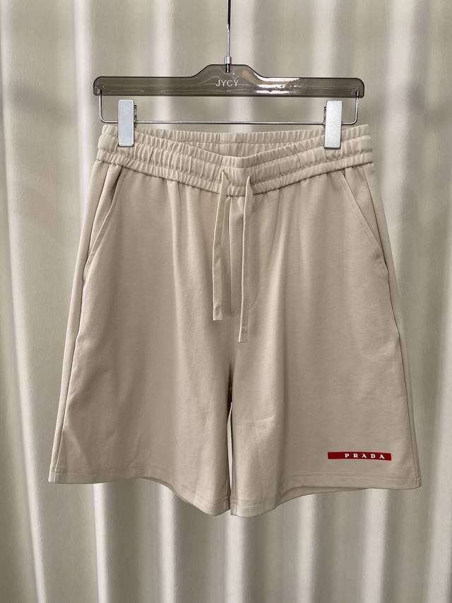 Prada. Summer men's casual shorts with brand logo, red badge on the left side of
