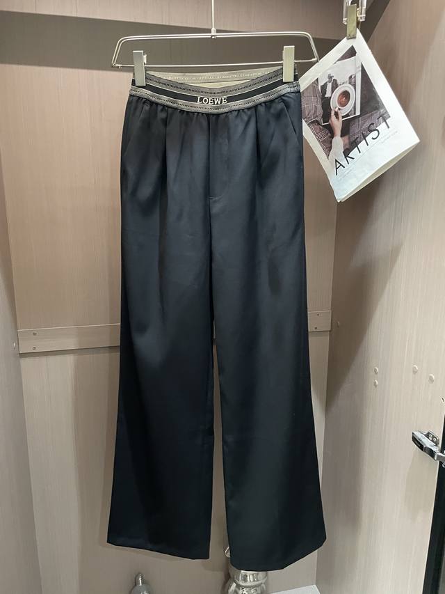 Loewe black wide-leg pants, with a letter ribbon at the waist, and a drapey fabr