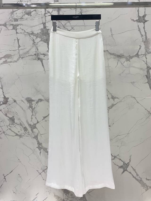 Saint Laurent's natural silk pleated shirt paired with wide-leg pants of the sam