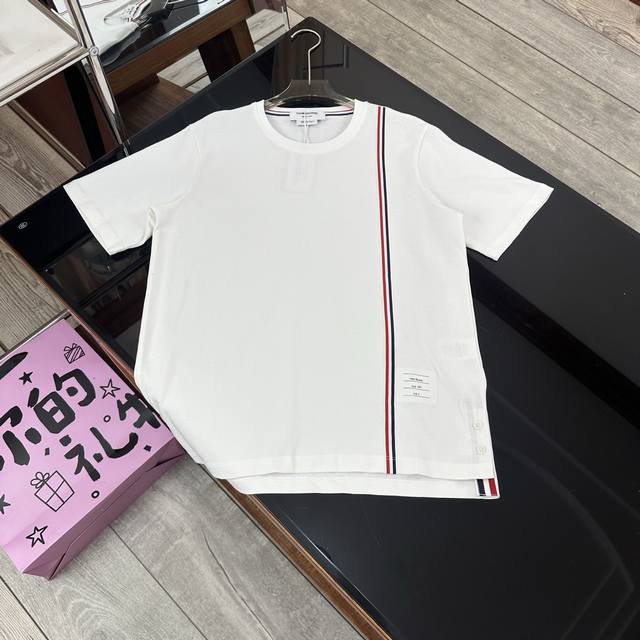 Thom Browne. Tb round neck T-shirt with long ribbon on the left side, short fron