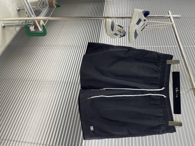 Celin Logo detail tech fabric sports shorts. Custom-woven tech polyester fabric,