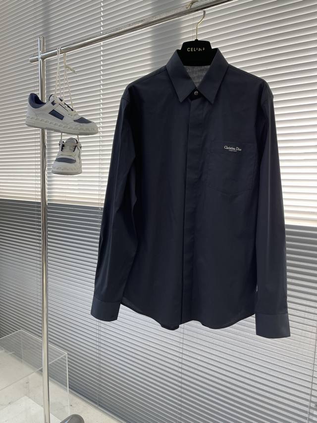Dio Poplin shirt with pocket embroidery details. Concealed button style, this fa