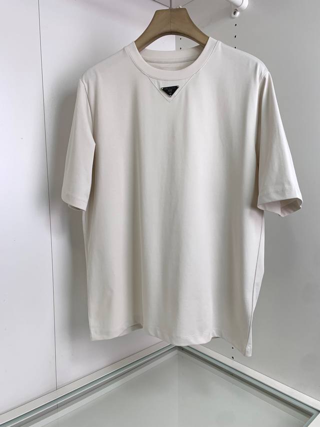 The classic logo triangle is embellished with a slightly wide round neck short-s