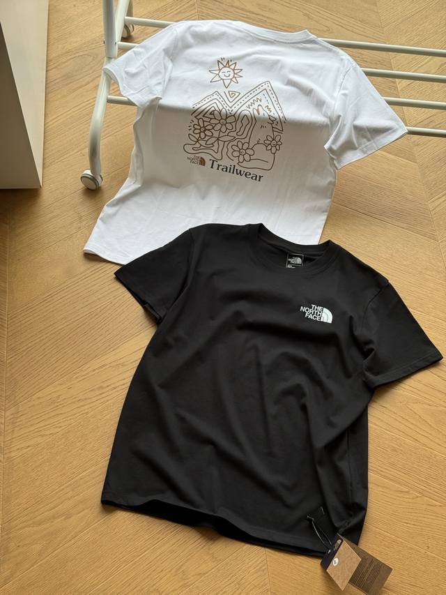 The North Face Sunflower Print Short-Sleeve Tee. Unisex Black and White. Availab