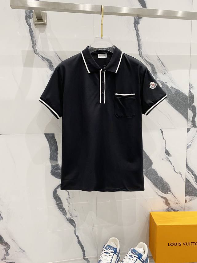 Moncler lapel polo shirt with contrasting lines, pocket badge and small logo. Of