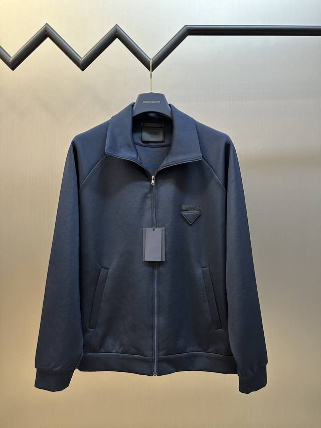 Prada This jacket with a triangle logo on the fabric is made of 80% natural cott