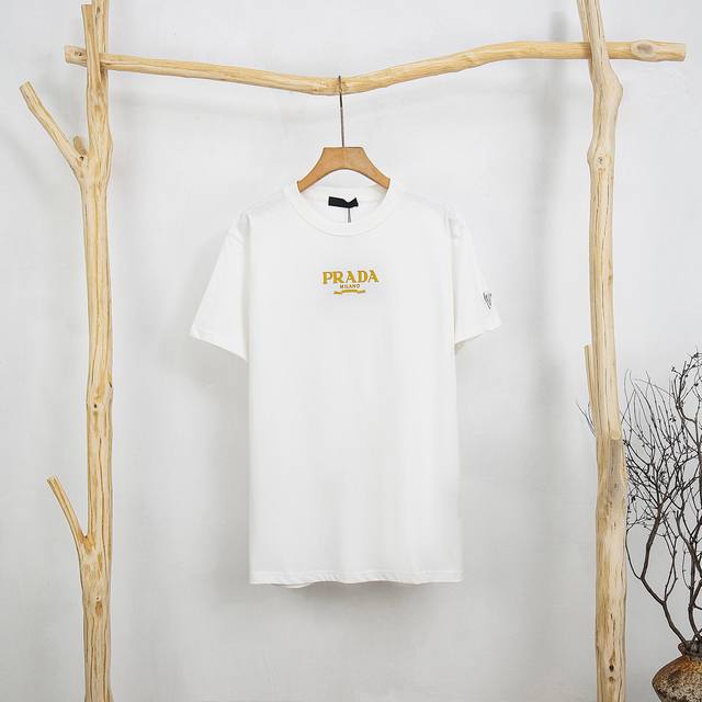 Prada classic short-sleeved triangle T-shirt with printed sleeves on the front.