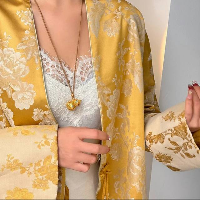 Chinese gold enamel brushed gourd with brocade rope, using gold as ink and broca