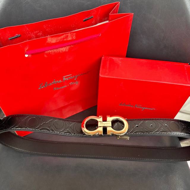 Ferragamo gold-embossed belt. This classic Ferragamo belt features a double-side
