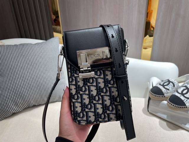 The Dior Lock phone bag, featuring a silver lock and a square box, is truly styl
