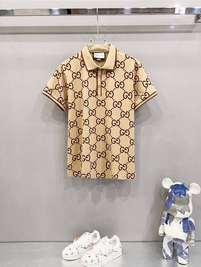 Gucci lapel polo shirt with all-over GG monogram print and color-block stripes.