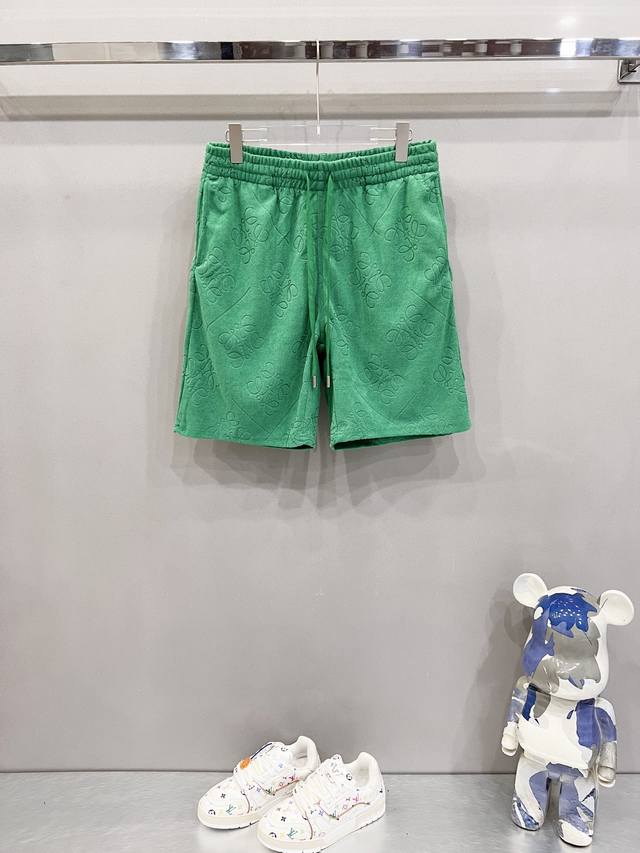 Loewe custom jacquard shorts with all-over floral print and totem logo. Official