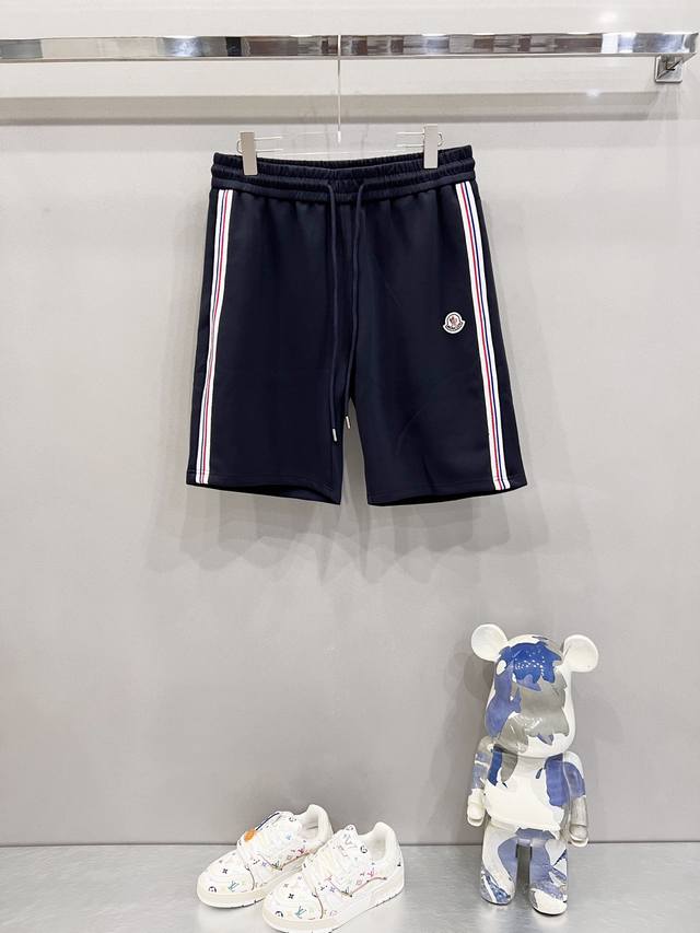 Moncler custom-made space cotton shorts with red, white, and blue webbing. Offic