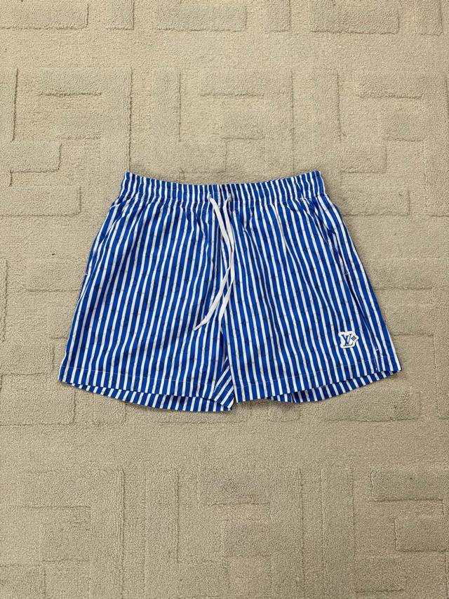 Flat-Detailed Lv Blue Striped Beach Shorts. These beach shorts feature an all-ov