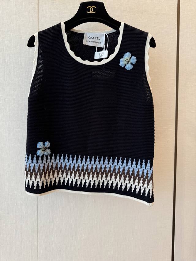 Cc Chane's new knitted contrast sleeveless vest features a geometric contrast de