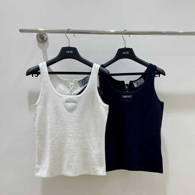 New summer styles! Prada's reversible vest features a unique strap design and a