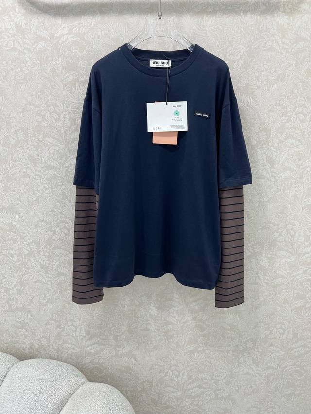 Miumi*25's new round-neck, faux two-piece long-sleeved T-shirt features a sophis