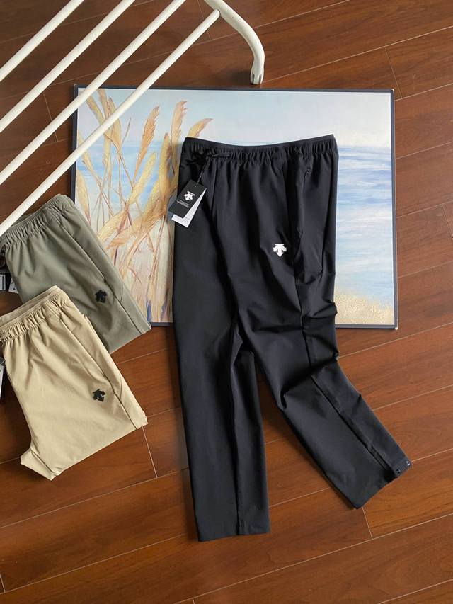 For Descente men's water-repellent woven athletic trousers DDD. These are a pop