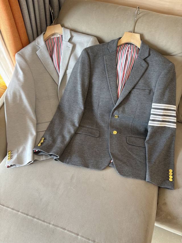 Tu New arrival: Tb's new classic three-button wool blazer. This unisex jacket fe