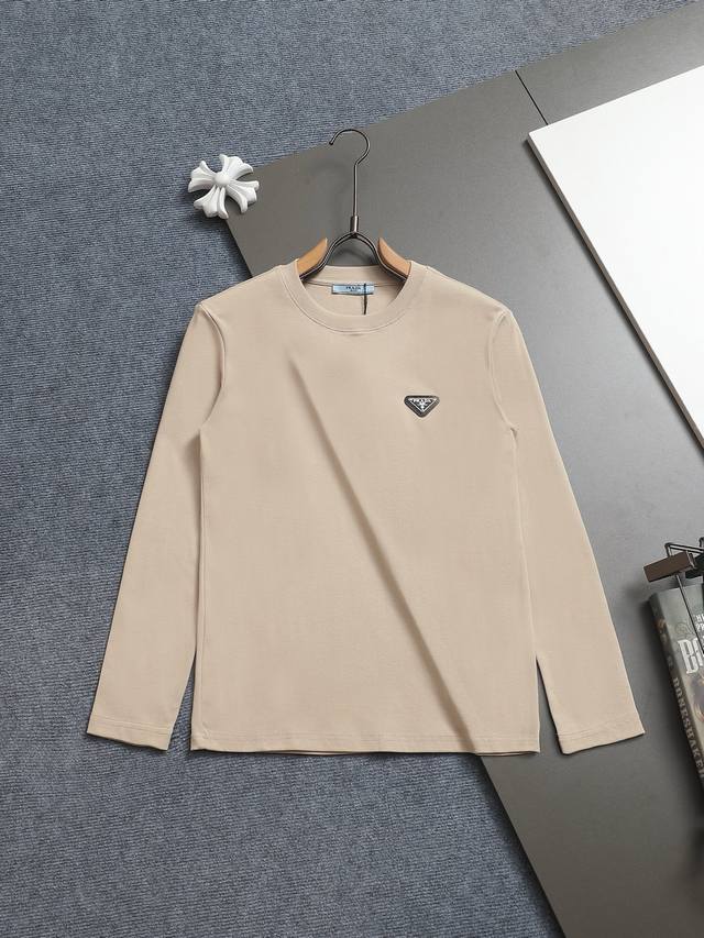 Prada's minimalist classic triangle logo has been refined and updated, inspired