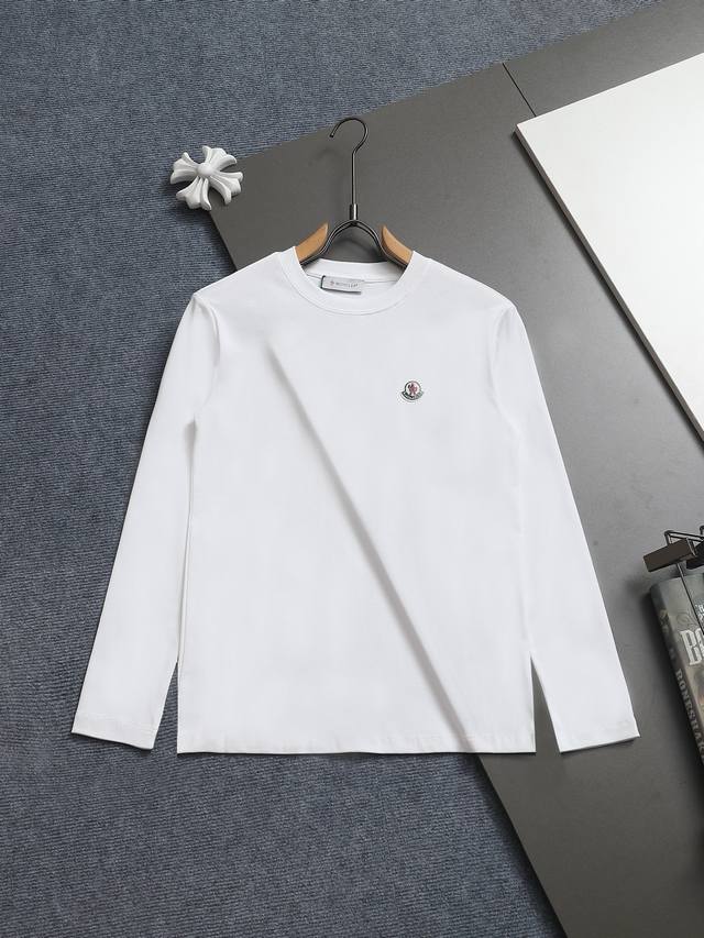 Moncler's minimalist classic badge Logo has been refined and updated, inspired b