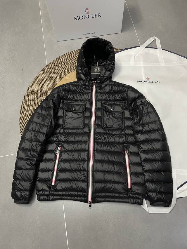 Counter updates! The Galion hooded down jacket features a straight cut and a ch