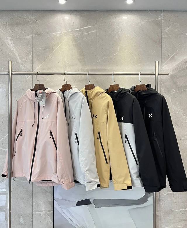 Under Armour unisex jackets in white, gray, black, turmeric, and pink. Available