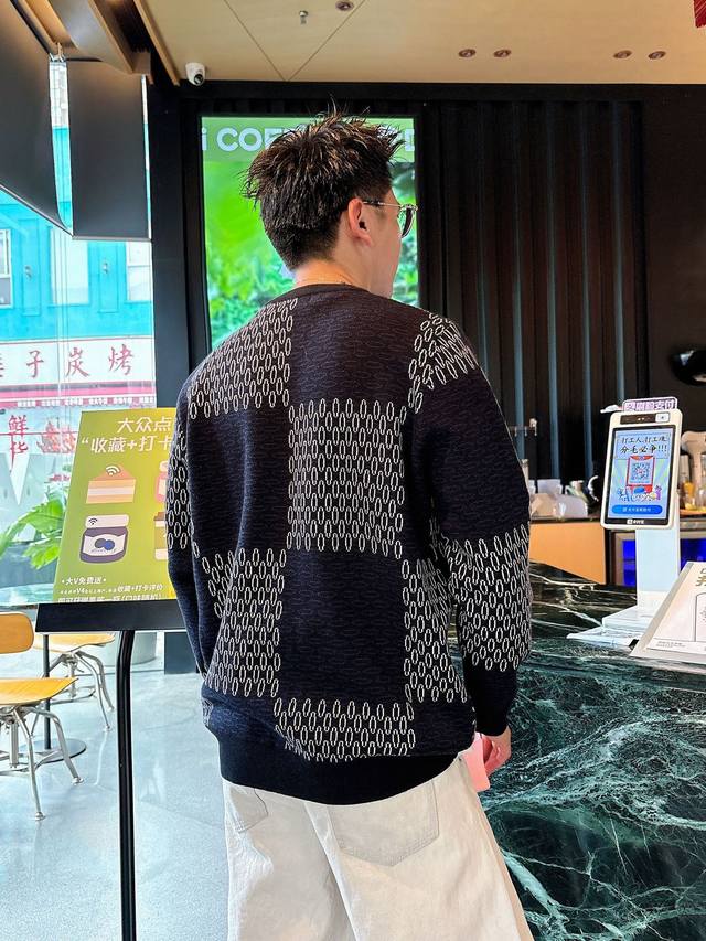 Changed price Lv checkerboard knit sweater. The deep, tranquil blue base resembl