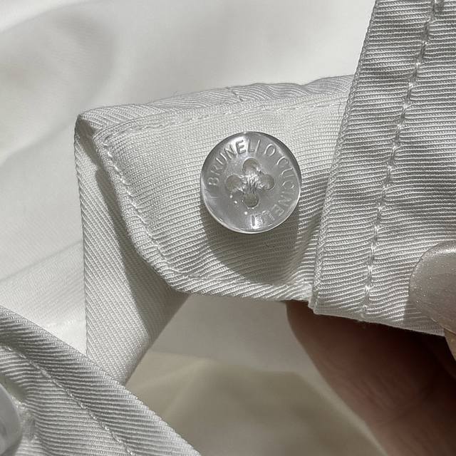 Brand-stamped mother-of-pearl button closure at the placket!! Unique luster and