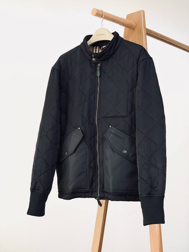 Burberry's Quilted Puffer Jacket features a classic black hue for a calming and