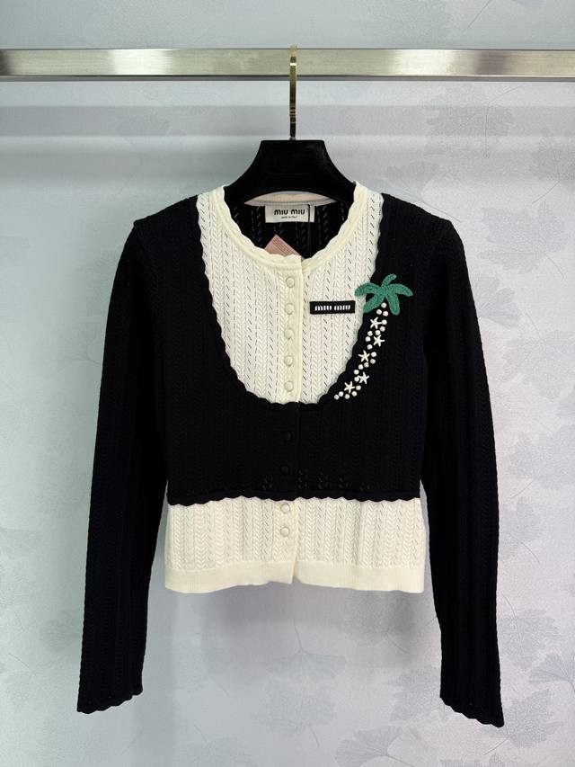 Miu*'s new early fall 2025 knitted cardigan features a contrasting black and whi