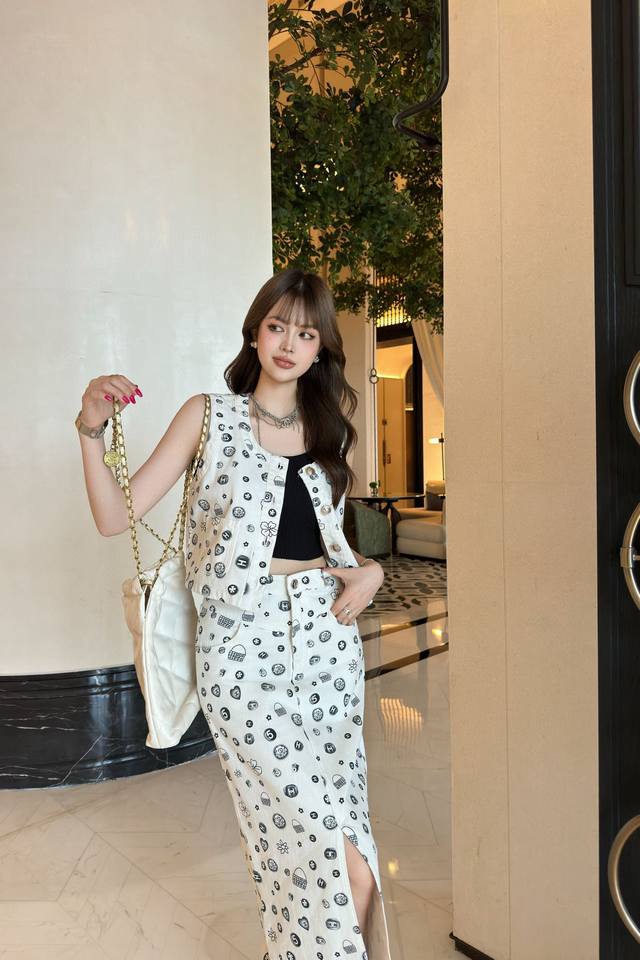 This Chanel-style denim vest with a colorful print and small bag is stylish, lo