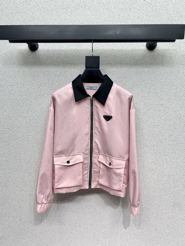 P's pink jacket with a triangle logo and zipper is stylish, understated, and lux