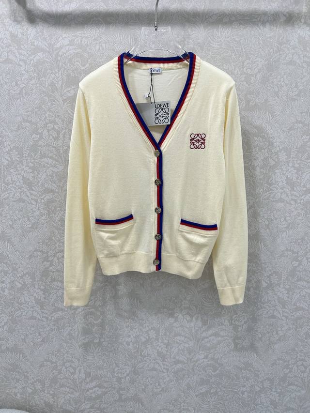 Loew**25's new V-neck knitted cardigan features a custom logo embroidery on the