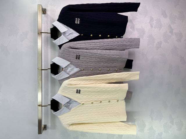 Miu*25's new early fall faux two-piece knit cardigan features an embroidered log