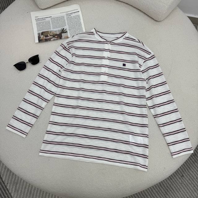 Casual and stylish Ac 25 early autumn striped knit top with a smiley face logo.