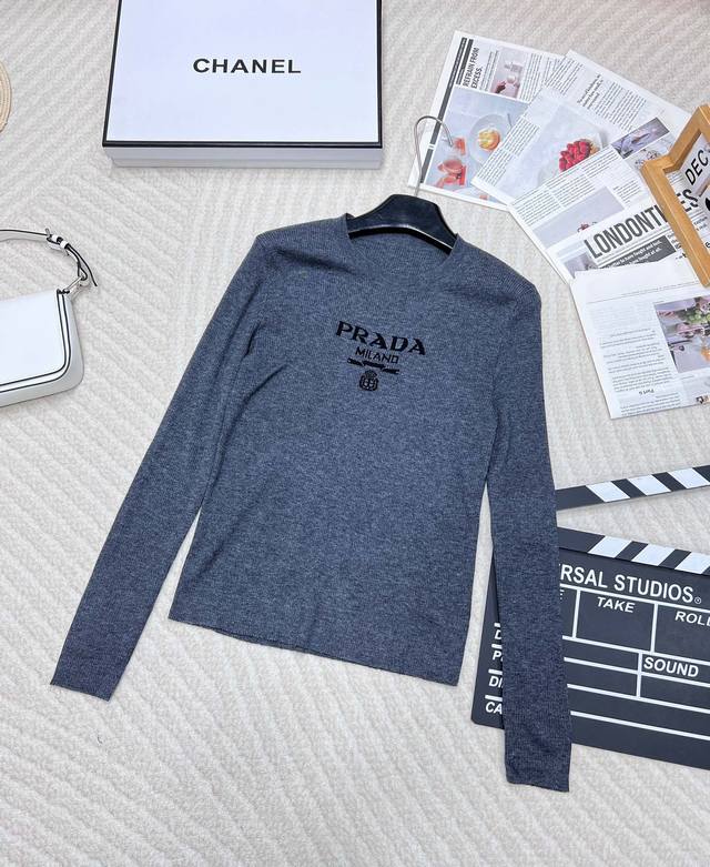 Prada's classic logo intarsia on the chest features a short, long-sleeved sweate