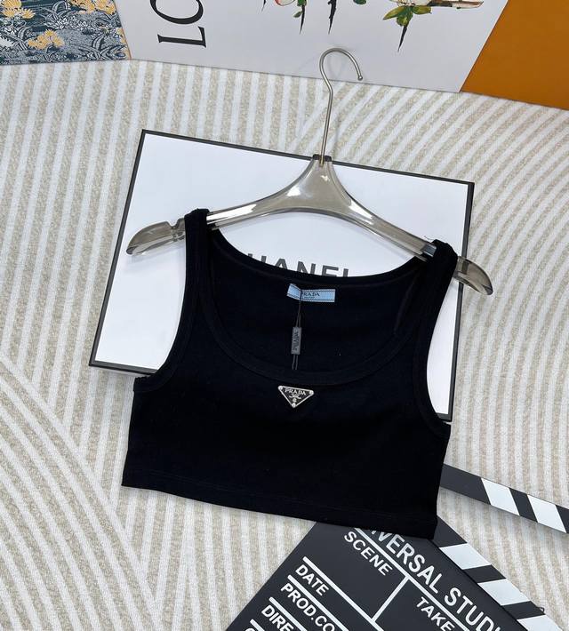 Prada's classic triangle logo cropped vest (DDD) offers a casual, sophisticated