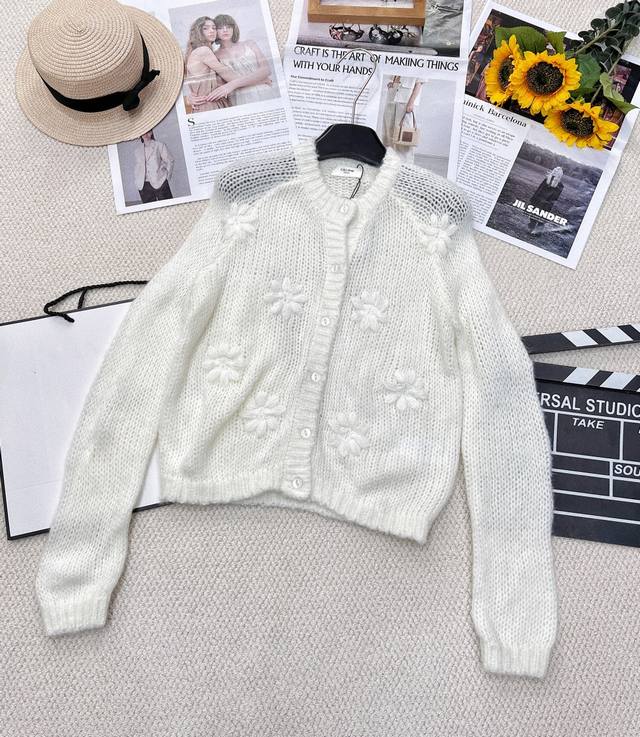 Celine's early spring hand-crocheted Arc de Triomphe knitted cardigan has a lazy