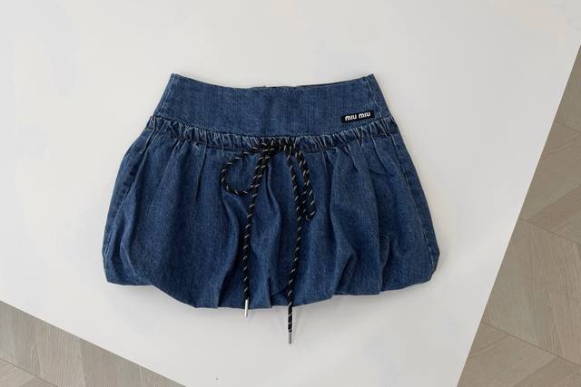 25 New Miu Miu denim shorts with a high waist and drawstring detail. These short