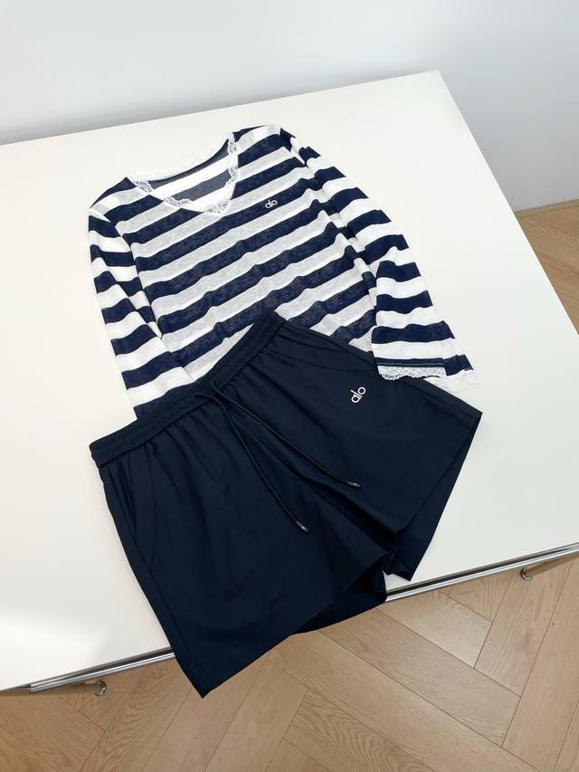 25 New casual wear includes a striped V-neck lace top and black shorts, both wit