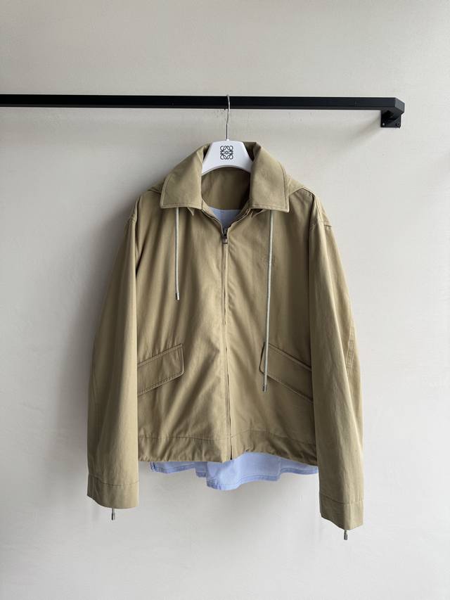 Loew*'s classic khaki trench coat has a new look. The slightly different lengths